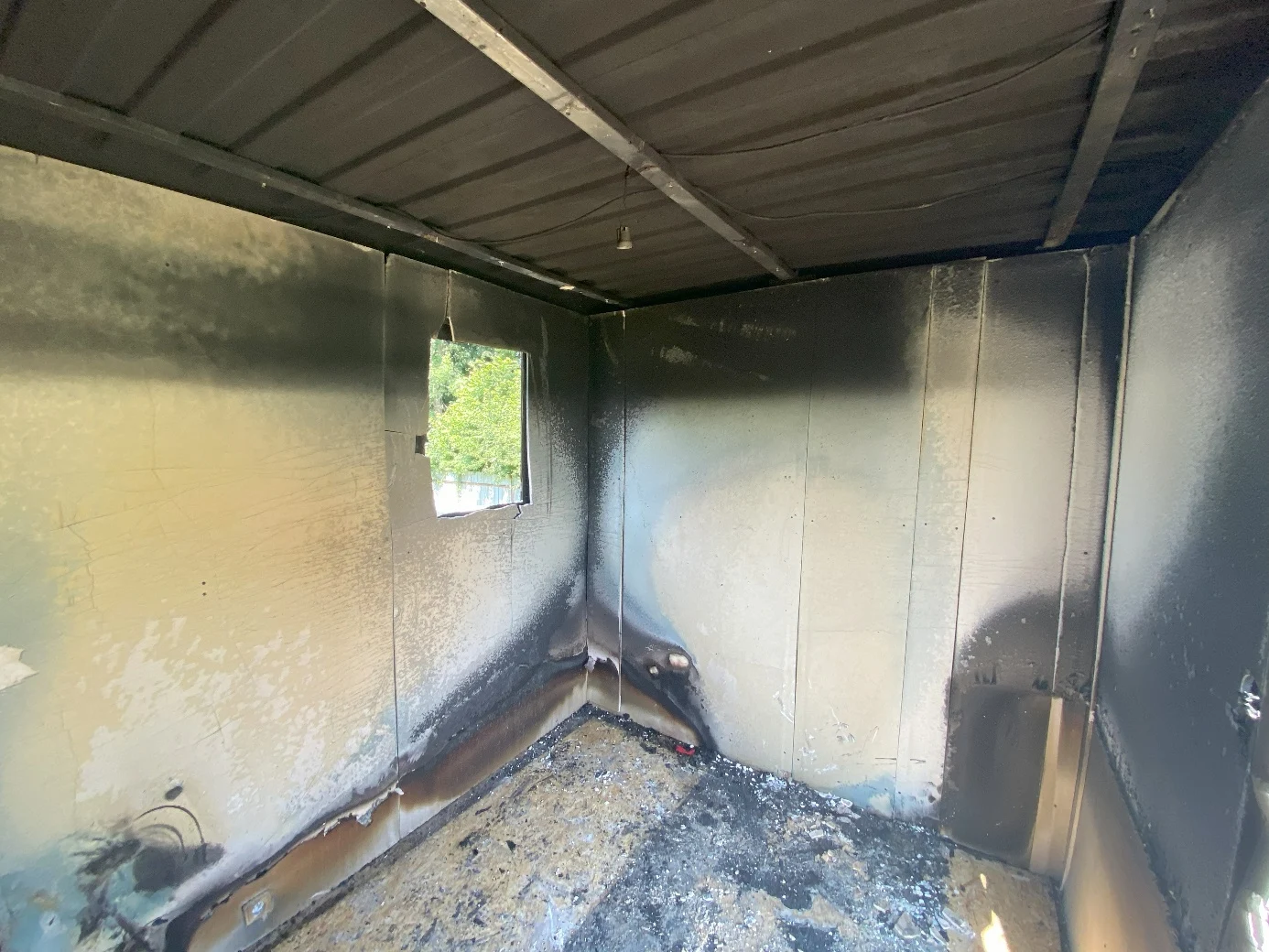 Opposite side of the fire compartment, showing a V-shaped burn pattern away from the origin